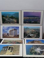 Wide shot showing all eight plaque style pictures featuring ancient Greek ruins and landmarks arranged in two rows.
