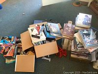 pile of boxes and loose media on carpet