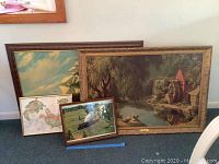 Four framed wall art pieces showing a watermill, sailing ship, fish illustrations, and a steam train.