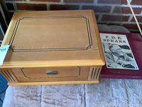 Closed wooden turntable box with decorative black inlay, next to the 'F.D.R. Speaks' vinyl record cover.