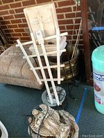Photo showing wooden plant stand, small barrel style planter, angel water fountain sculpture, and four decorative water globes.