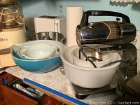 Photo of Power Mix vintage stand mixer with white mixing bowl and additional turquoise Pyrex bowls on counter.