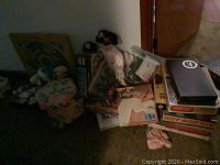 Full lot showing collection of boxed board games, calligraphy set, dolls, and kits. Items stacked with some visible labels including Hot Rod Kit and Calligraphy set.