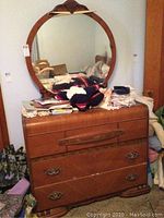 Full view of vintage wooden dresser with round mirror, showing overall size and condition.