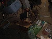 Boxes and bags filled with various books and magazines of mixed size and condition.