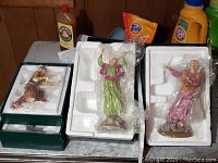 Six Franklin Mint religious-themed figurines in protective styrofoam with clear wrappings in some cases.