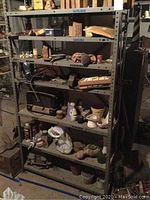Metal shelving unit with vintage radio, boxes, pots, and vases