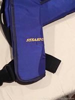Close-up photo of the blue Stearns branded life jacket showing logo and fabric texture.