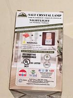 Packaging for salt crystal lamp night light showing product features, warnings, and electrical ratings.