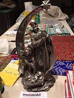 Holy Family statue with antique silver paint and damaged star, displayed on table with other holiday items