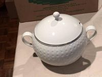 White ceramic bowl with handles and matching lid, bubble texture and silver rim, no chips