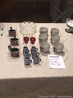 Full lot display showing all items including ceramic bowls, glasses, and miniature mugs