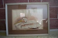 Front view of the framed watercolor painting of a pelican showing the entire artwork and frame