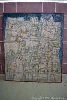 Full frontal view of painting leaning against wall showing overall composition and frame