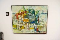 Frontal view of abstract oil painting on canvas depicting clustered house shapes in various colors