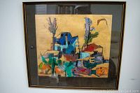 Front view of framed abstract painting with gold background and vibrant shapes