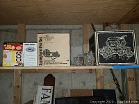 Three shelves with boxed and loose kitchenware and glassware displayed, including Pampered Chef Springform Pan Set and Black & Decker Egg Slicer.