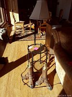 Full view of end table lamp combo and two matching animal leg base lamps in living room setting