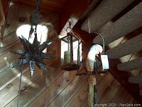View of all three hanging decor items together including parrot, star, and lantern