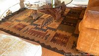 Overhead view showing rug under glass coffee table and sofa with full southwestern geometric pattern