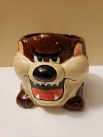 Front view of the ceramic mug showing Taz's face and open mouth.