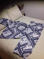 Navy and white patterned pudama set laid flat on bed to show full design and appearance.