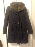 Front view of black Biana Nygard winter jacket with belted waist and faux fur hood.