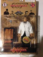 Full view of unopened action figure package showing Sean Connery figure in white tuxedo, pistol and briefcase accessories, and Goldfinger branding.