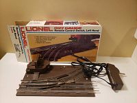 Lionel 027 gauge remote control switch, left-hand track direction with original box and remote lever wired attachment.