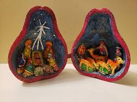 Open view showing two halves of the split gourd containing a painted nativity scene with figures placed in separate compartments.