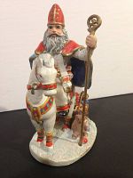 Gaghant Baba figurine on white background showing detailed front and side profile with staff and horse.