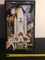 Full front cover of the sealed Moonraker space shuttle model kit box showing the space shuttle and characters from the James Bond film.