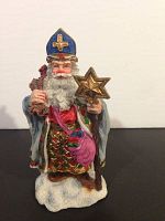 Front view of Poland Santa figurine holding a star and staff, detailed hand-painting visible