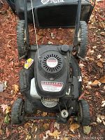 Top view of the lawn mower showing the Gardenway label, Honda 5.5 HP engine, and controls.