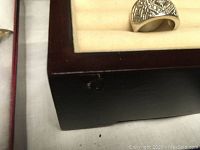 Close-up photo of jewelry box corner with visible ding/dent