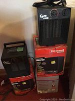 Four heaters stacked, including two boxed Honeywell ceramic heaters and two black Super Furnace heaters on top and side.