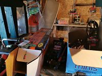 Photo showing Remington chainsaw box, Black & Decker hedge trimmer box, automotive jack, and part of a blue box.