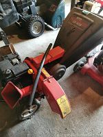 Side view of chipper showing chute, wheels, and engine