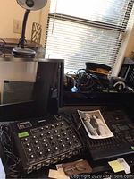 Overview of Centaur amplifier, Tascam mixer, cables, headphones, hat and eyeglasses on desk