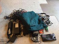 Top-down view of Yamaha pedal, cables, and green carryall bag on carpet.