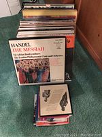 Photo of a stack of vinyl LP records with Handel The Messiah album on top, conducted by Sir Adrian Boult with The London Philharmonic Choir and Orchestra
