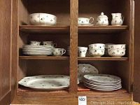 Cabinet with plates, cups, bowls, creamer, sugar bowl, saucers