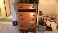 Full front view of chest of drawers with drawers closed and some partially open, showing overall look and condition.
