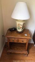 Photo of the nightstand with lamp on top, showing overall condition and design of both items