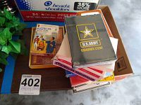 Top view of stacked playing card decks, showing U.S. Army deck in plastic wrap and political trivia cards.