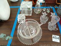 Vintage glass decor items including two star candlesticks, Shannon crystal bow jars, and glass figurines.