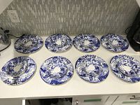 Eight soup bowls arranged on countertop