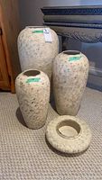 Set of 4 pottery items including 3 vases and 1 bowl, showing overall grouping on carpeted floor.