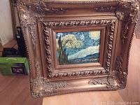 Full view of the acrylic painting within the large ornate gilt frame, showing detailed embossing and the stylized Starry Night-inspired scene.