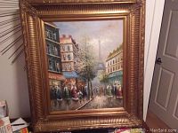 Full view of acrylic painting in ornate gilt frame showing Paris street scene with Eiffel Tower